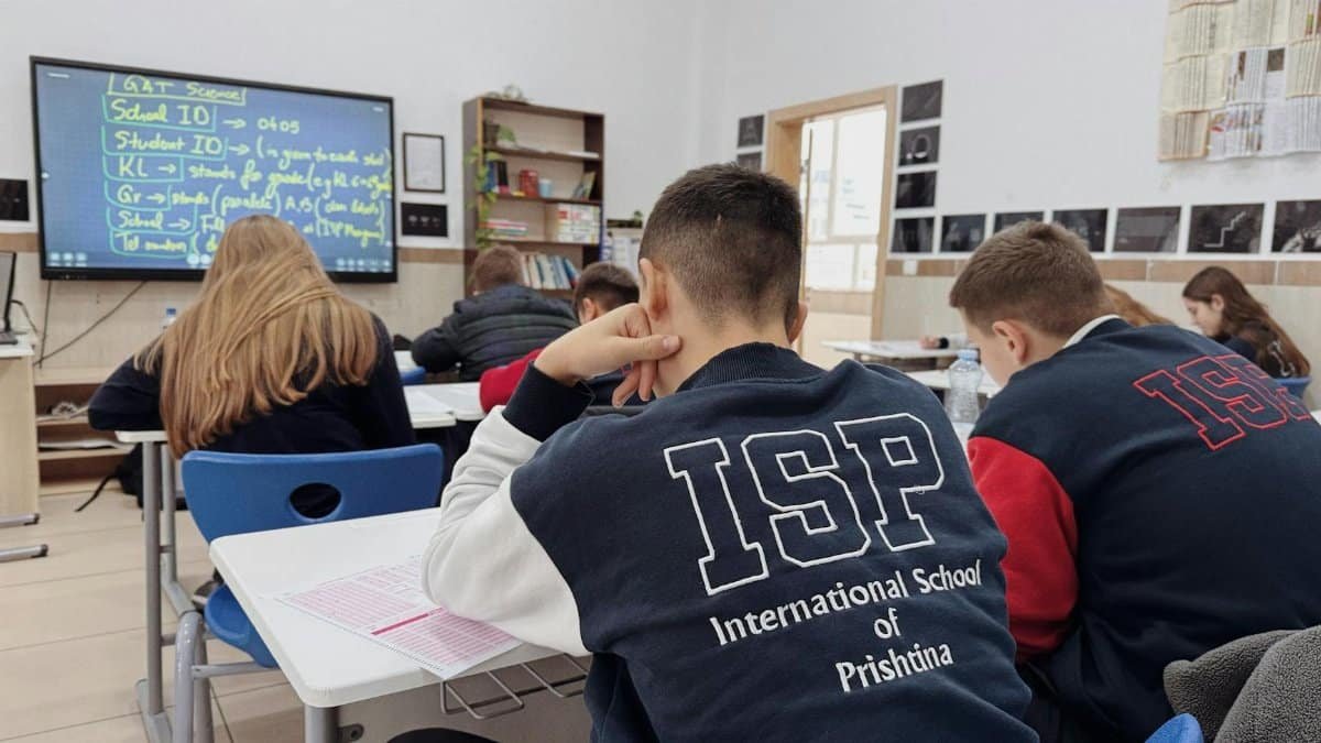 Students attentively learning in a classroom at the International School of Prishtina.
