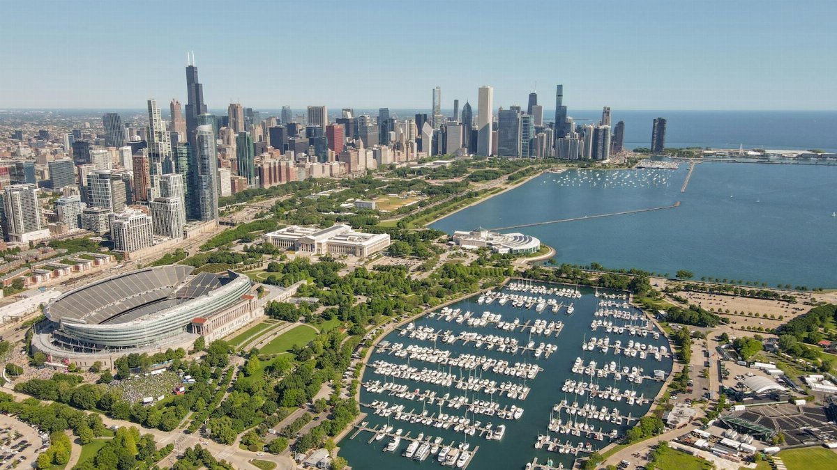 A stunning aerial shot of Chicago's skyline and Lake Michigan with Soldier Field in sight.