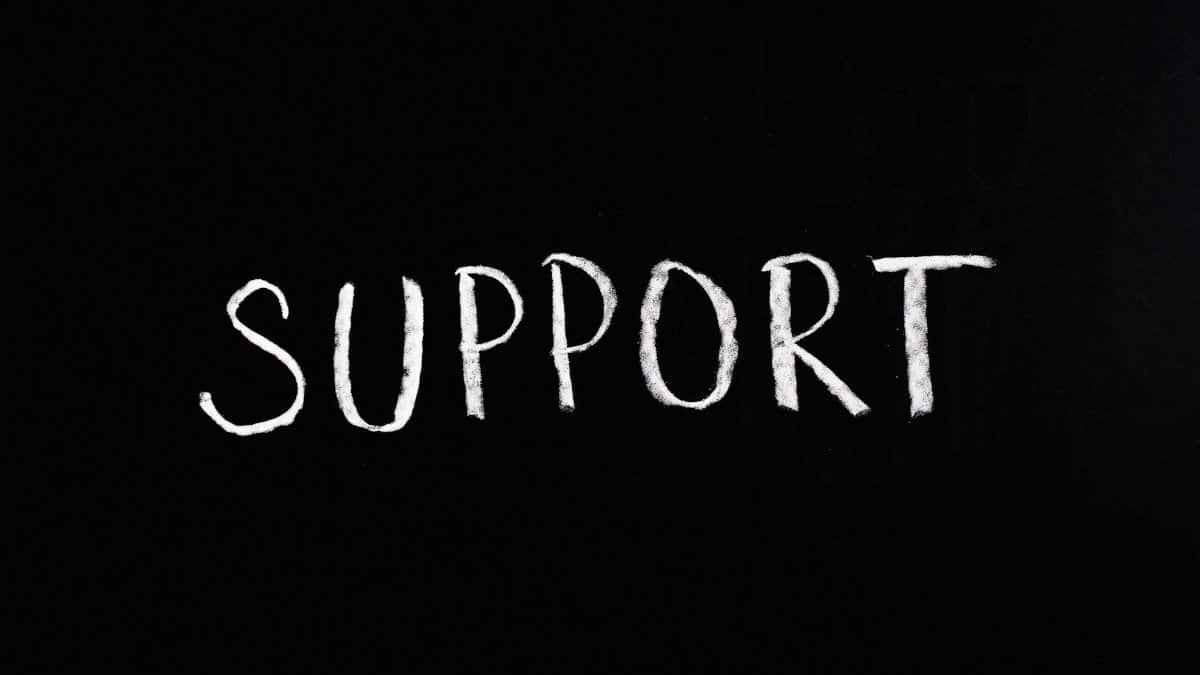 Chalkboard with the word 'Support' written in white chalk on a black background.
