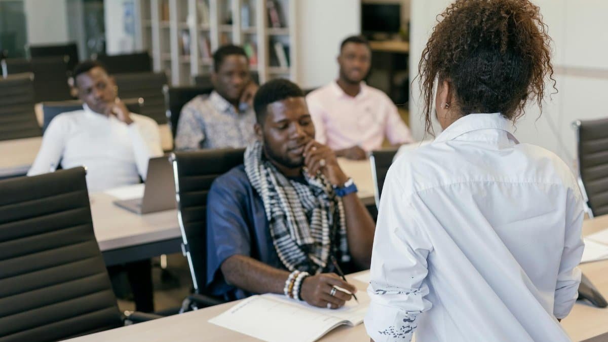 A group of professionals engaging in a training session in a modern office setting.
