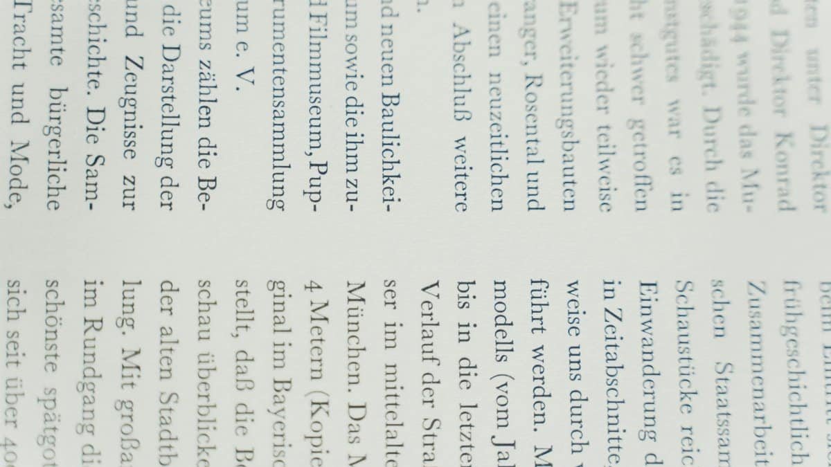 Detailed close-up of German text printed on white paper, focusing on typography.