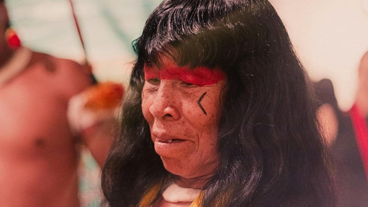 Close-up of an indigenous woman with traditional red face paint in Brazil.