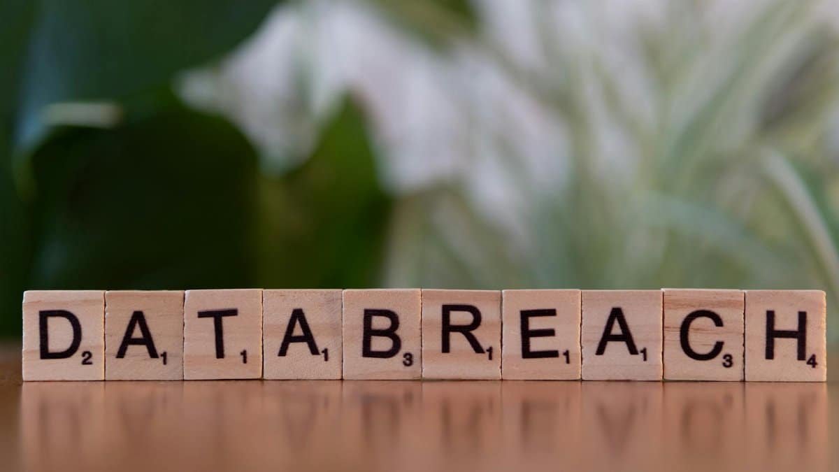 Close-up of Scrabble tiles spelling 'data breach' on a blurred background