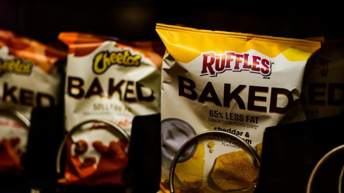 Close-up of a vending machine showcasing baked snacks like chips for a tasty treat.