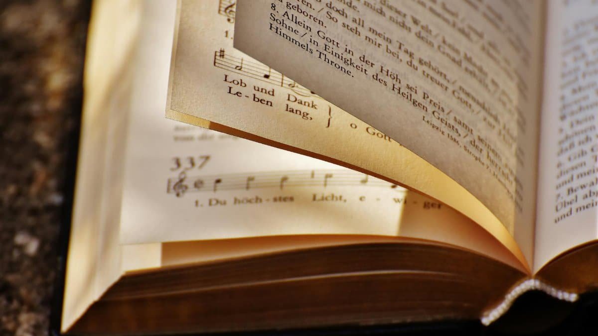 Close-up of an open book displaying sheet music and text, capturing literary and musical essence.