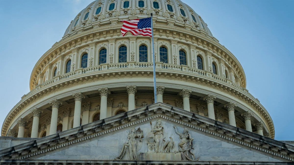Close-up view of the iconic United States Capitol dome with American flag in Washington, D.C.
