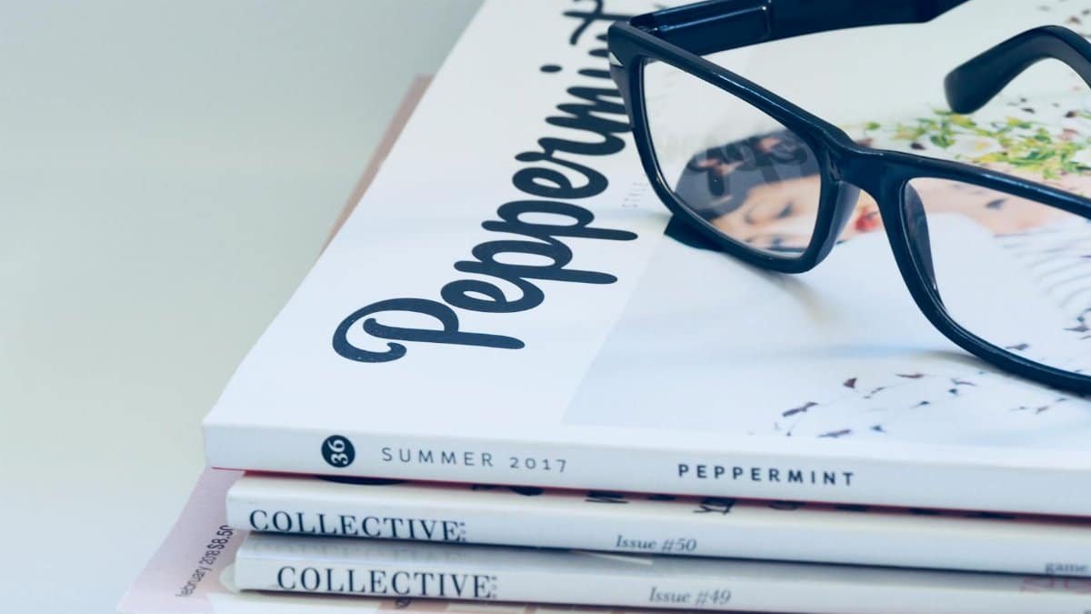 Eyeglasses on a stack of fashion and lifestyle magazines including Peppermint and Collective.