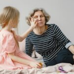 A touching moment of a grandmother and granddaughter bonding on a bed, highlighting family love.