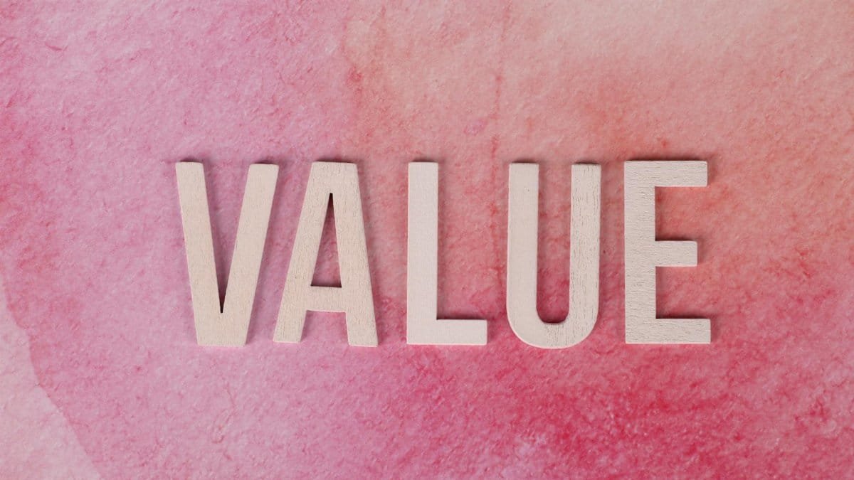 The word 'VALUE' in bold letters on a textured pink background.