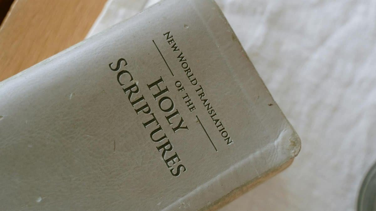 A close-up photo of the New World Translation of the Holy Scriptures on a table.