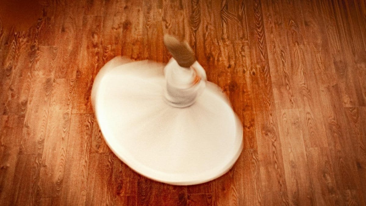 Aerial view of a whirling dervish in motion. Captivates the essence of Sufi dance indoors.