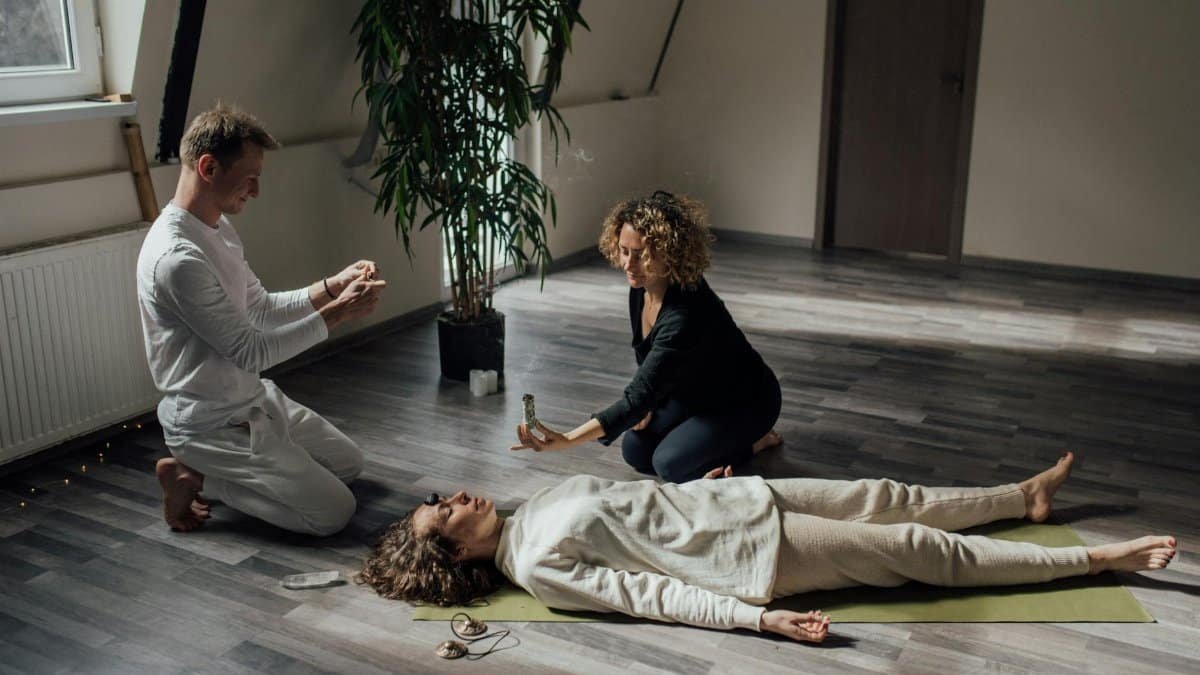 Meditation session indoors with incense and wellness practices.