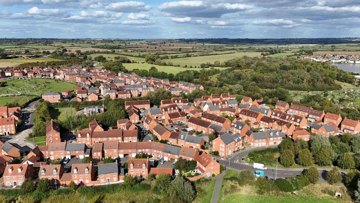 A stunning aerial view of residential housing in Aylesbury, England surrounded by lush landscapes.