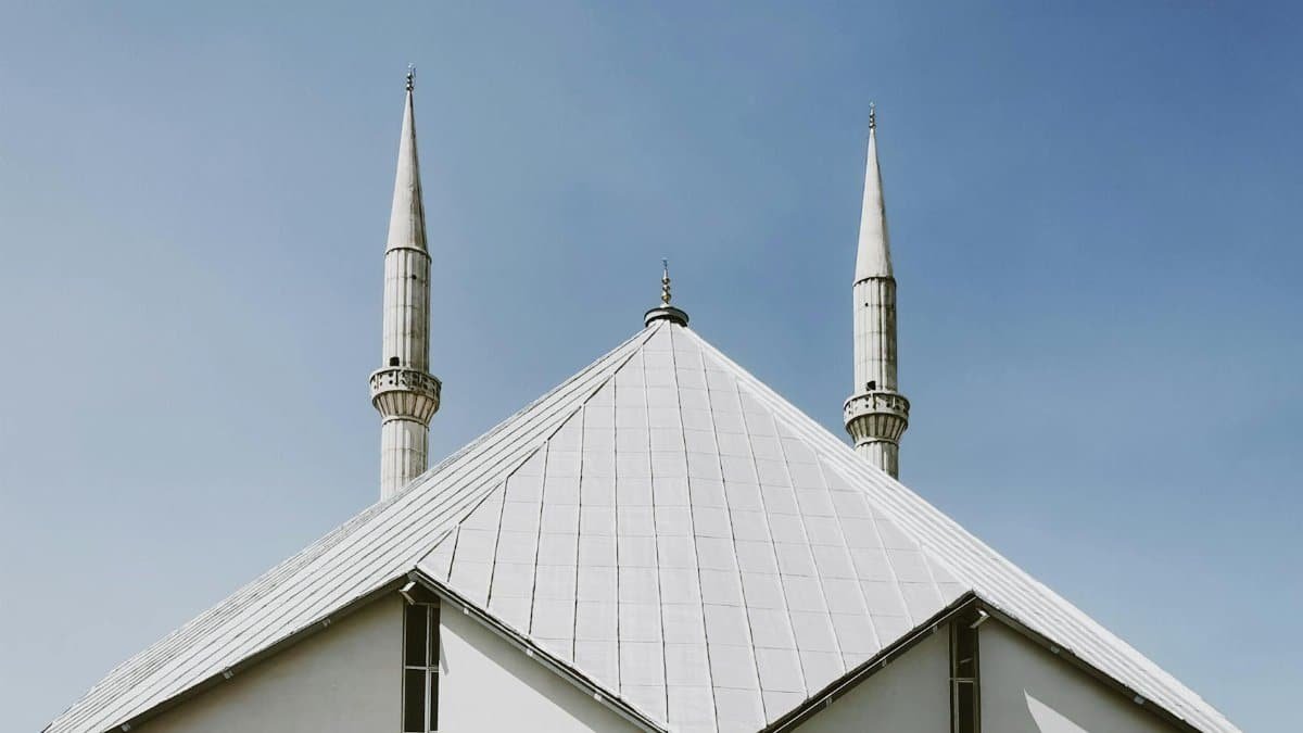 A striking view of Shah Faisal Mosque's contemporary structure against a clear sky.