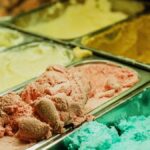 Close-up of various ice cream flavors in a shop freezer, perfect for summer treats.