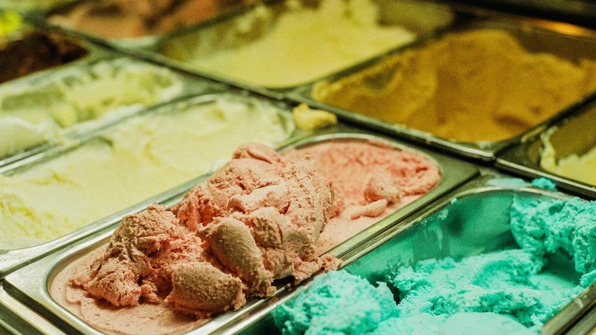 Close-up of various ice cream flavors in a shop freezer, perfect for summer treats.