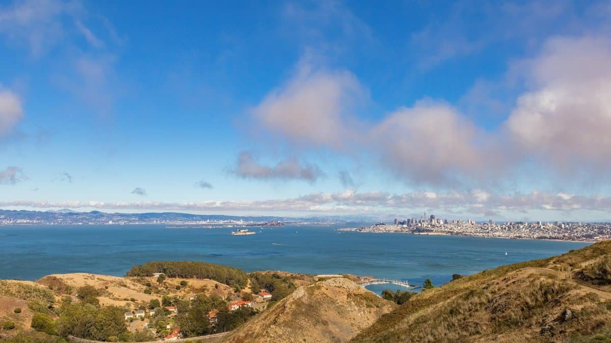 Scenic aerial view of San Francisco Bay with the city skyline, blue sea, and clear sky.