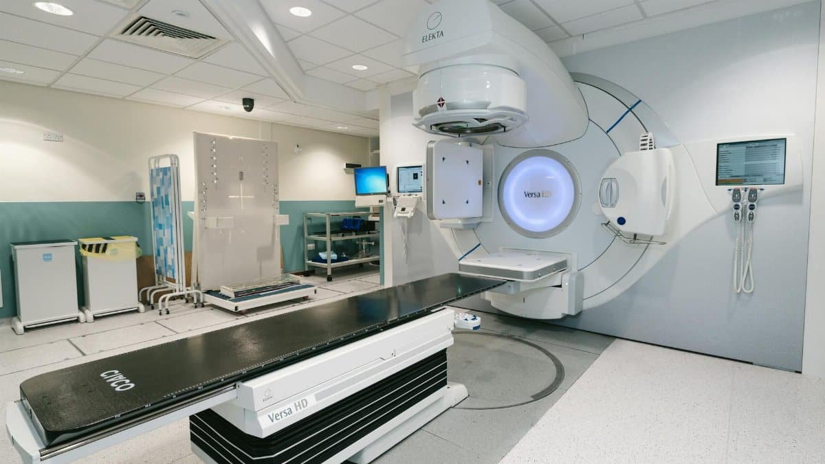 High-tech radiotherapy machine in a hospital's clinical setting for patient treatment.