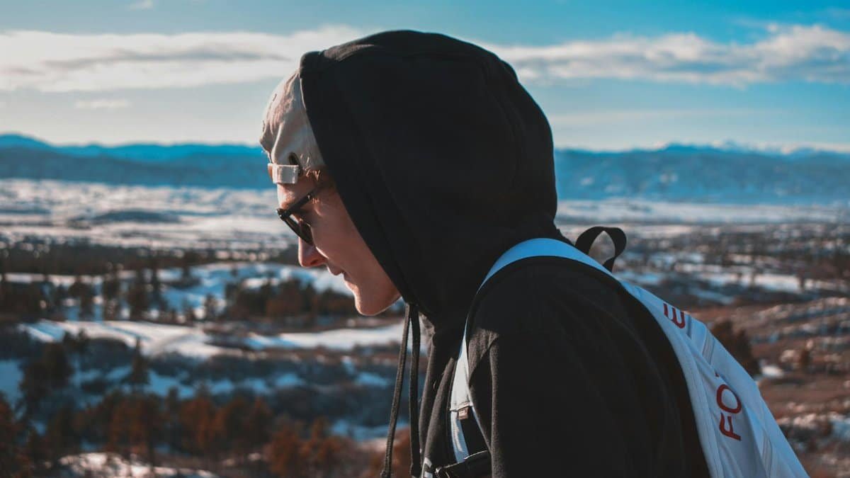 Portrait of a man hiking outdoors in Highlands Ranch, Colorado on a bright winter day with scenic mountain views.