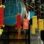 Colorful red and gold lanterns hang at an outdoor market celebrating Lunar New Year.