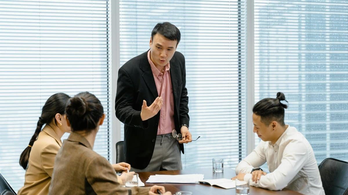 A group of professionals engaged in a business meeting in a modern office setting.