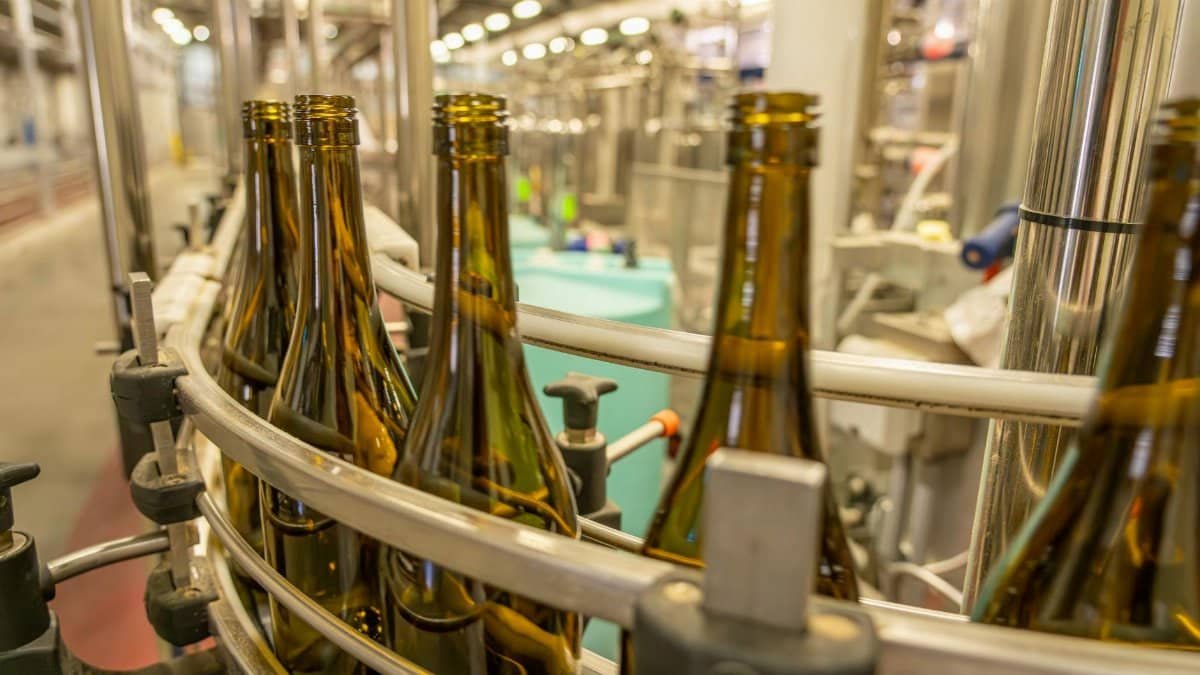 Close-up view of glass bottles on an industrial production line in a manufacturing facility.