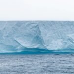Stunning iceberg in Antarctica showcasing pristine ice formations above the ocean.