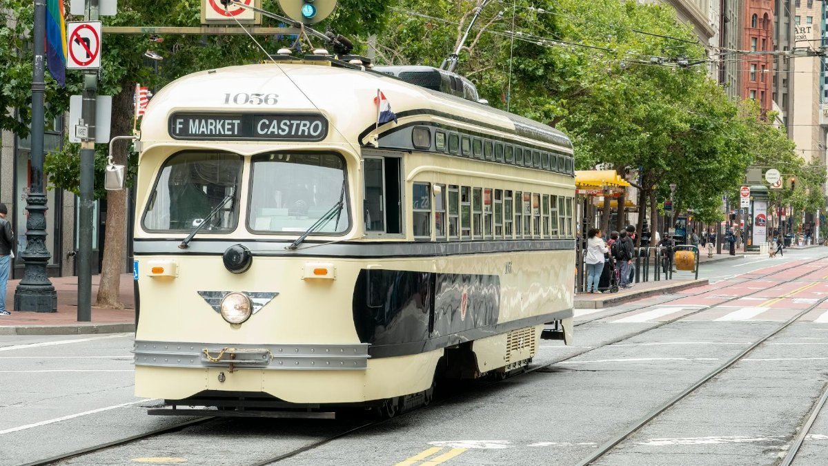 A charming streetcar travels through San Francisco's bustling cityscape on the F Market & Castro line.