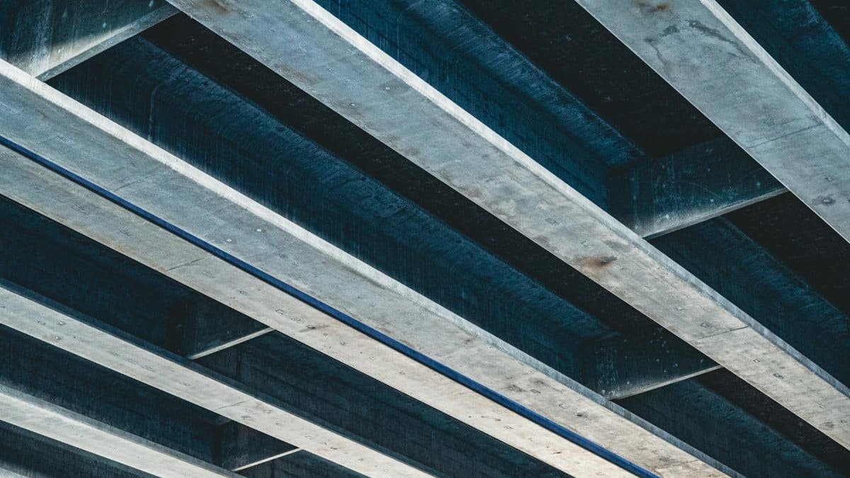 Low angle shot of an industrial steel and concrete ceiling structure.