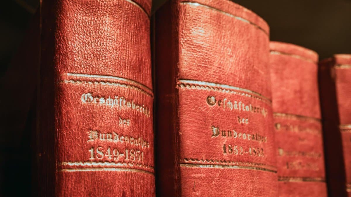 Red leather-bound parliamentary books from 19th century in Bern library, Switzerland.