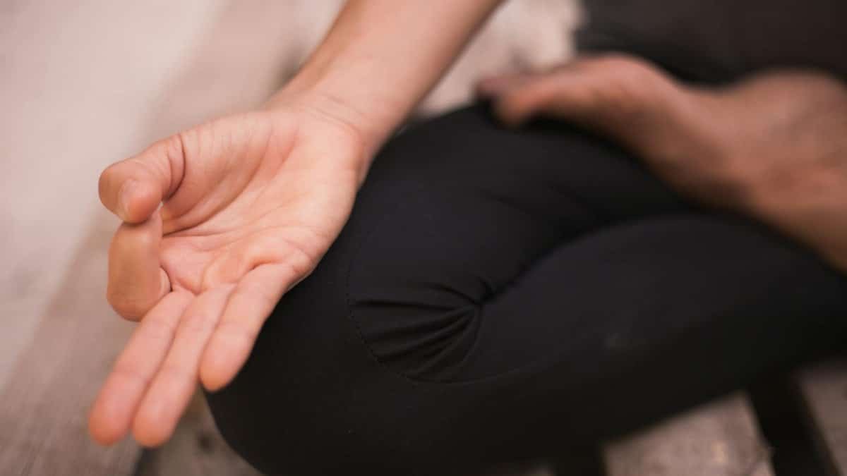 Close-up of a hand in a meditation pose, focusing on mindfulness and calmness.