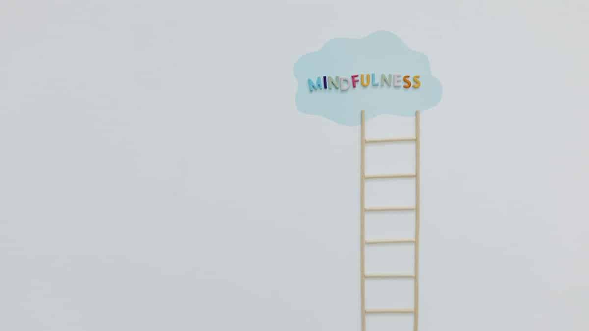 Creative mindfulness concept with a ladder and cloud on a minimalist white backdrop.