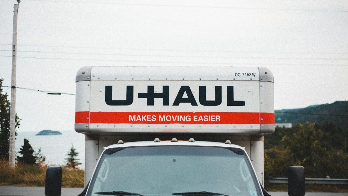 U-Haul moving truck parked on roadside with scenic outdoor backdrop.