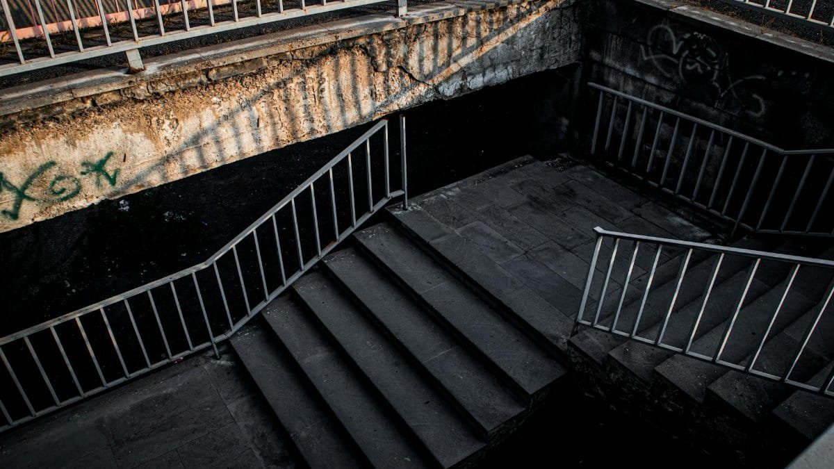 Brutalist urban stairs in Yerevan with dramatic lighting and gritty atmosphere.