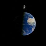 Stunning view of Earth with the Moon in space, highlighting the cosmic beauty.