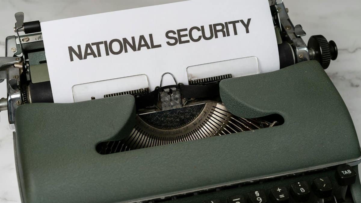 Close-up of a vintage typewriter with a paper marked 'National Security', symbolizing confidentiality.
