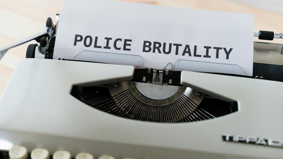 Close-up of a typewriter with the text 'POLICE BRUTALITY' on paper, highlighting the message of awareness.
