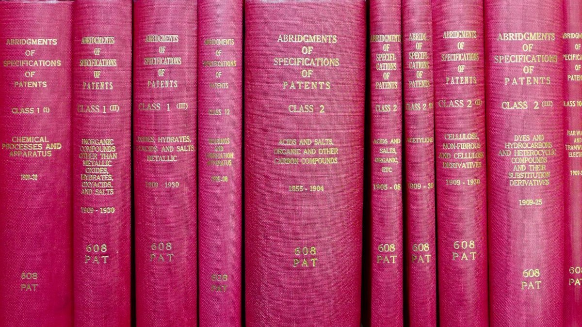 A row of red hardcover books titled 'Abridgments of Specifications of Patents'.