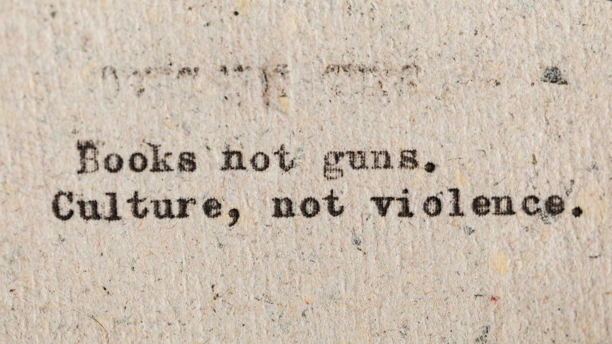 A vintage typewritten quote promoting culture over violence on aged paper.