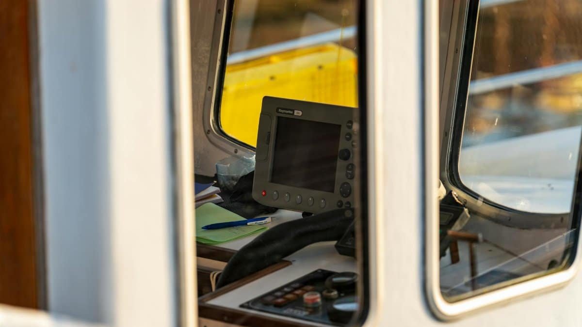 View inside a boat cabin in Kołobrzeg, Poland, showcasing navigation equipment and controls.