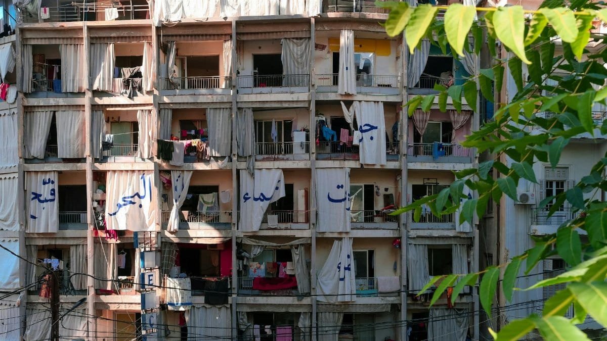 High-rise building in Beirut featuring open balconies and laundry hanging.