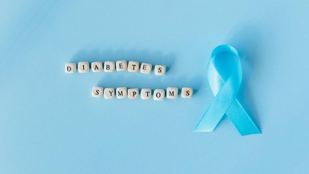 Conceptual image emphasizing diabetes symptoms with a blue awareness ribbon and letter dice.