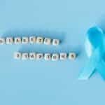 Conceptual image emphasizing diabetes symptoms with a blue awareness ribbon and letter dice.