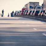 A congested highway with cars and trucks in a traffic jam during daylight.