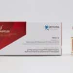 Close-up photo of antibiotic medicine packaging with vial on a white background.