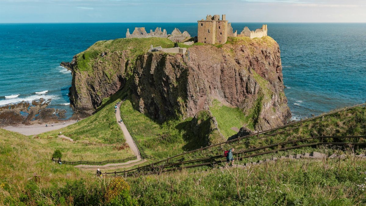 Scenic view of Dunnottar Castle perched on a cliff overlooking the North Sea in Scotland.