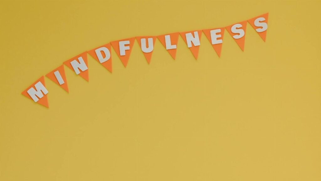 Banner with 'Mindfulness' on a bright yellow background, symbolizing calm and focus.