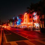 Lively Miami nightlife on Ocean Drive with illuminated Art Deco buildings and bustling streets.