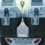 Photo of two parking meters in Orlando showing coin and card payment options on a brick road.