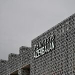 Contemporary geometric facade with 'Azerbaijan' text in Osaka, Japan, capturing modern architectural design.